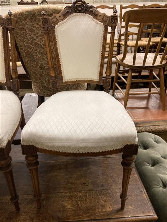 A pair of Victorian carved walnut salon chairs